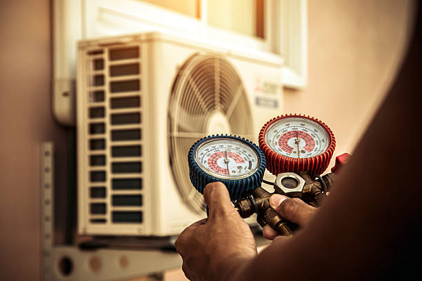 Professional Air Conditioning Service technician working in Pinehurst, MA